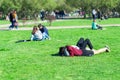 People resting in the Park. Girls lie on the green grass
