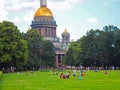 People are resting in the park next to the Saint Isaac`s Cathedral