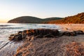 People resting on scenic beach Cala Violina at the sunset. Tyrrhenian Sea bay at the sunset