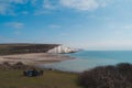 People resting at Seaford Head Nature Reserve and the Cuckmere Haven peacefull seafront beach at the top of the Chalk Cliffs walk
