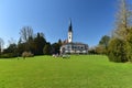People resting in the Villette-park in front of the Saint Jacob Church. Town of Cham, canton of Zug, Switzerland, Europe.