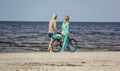 People ride a bicycle along the sea Royalty Free Stock Photo