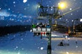 People ride in the chairlift at night