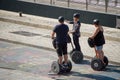 People ride the gyroboards along the Seine embankment under Alexander the Third Bridge in Paris