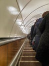 People ride a long escalator in the subway Royalty Free Stock Photo