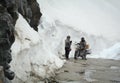 People ride motorcycle on the snow road in Khardungla, India