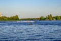 People ride PWCs and a boat on the Dnieper River in Kherson Ukraine. Beautiful landscape with tourists frolicking in the water