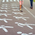 People ride a scooter in the park along a pedestrian crossing Royalty Free Stock Photo