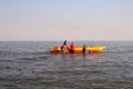 People ride the sea on an inflatable banana