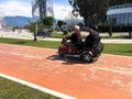 People ride in a small electric car, a golf car on the seafront on a sandy beach. Georgia, Batumi, April 17, 2019 Royalty Free Stock Photo