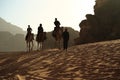 People rides on camels in Wadi Rum desert in Jordan Royalty Free Stock Photo