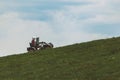 people riding on all terrain vehicle by mountains Royalty Free Stock Photo