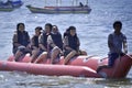 People riding on a banana boat in bali beach Royalty Free Stock Photo