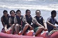 People riding on a banana boat in bali beach Royalty Free Stock Photo