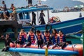 People riding banana boats while traveling to the beach Royalty Free Stock Photo