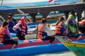 People riding banana boats while traveling to the beach