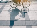 People Riding Bicycle shadow on street Urban Ecology lifestyle Royalty Free Stock Photo