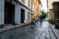 People riding bicycles in cobblestoned street in Gamla Stan in Stockholm