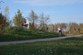 Girl riding on a bike on a rural road autumn landscape