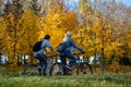 People riding on a bikes on a rural road autumn landscape in the Minsk city Belarus