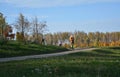 People riding on a bikes on a rural road autumn landscape blue sky background