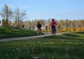 People riding on a bikes on a rural road autumn landscape in the Minsk city Belarus Royalty Free Stock Photo