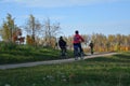 People riding on a bikes on a rural road autumn landscape Minsk city Belarus