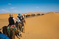 People riding camel in the Sahara desert, Morocco Royalty Free Stock Photo