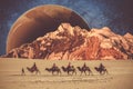 People are riding camels in a desert on a planet in the universe