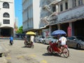 People riding cyclos on street at downtown in Penang, Malaysia