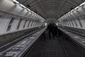 People riding the escalator of the Prague metro system. Ungerground stairs in the metro of Prague Royalty Free Stock Photo