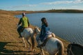 People riding horses in a rural landscape