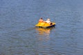 People riding pedalo boat on Khorol river in Myrhorod, Ukraine