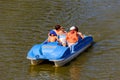 People riding pedalo boat on Khorol river in Myrhorod, Ukraine