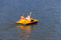 People riding pedalo boat on Khorol river in Myrhorod, Ukraine