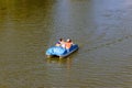 People riding pedalo boat on Khorol river in Myrhorod, Ukraine