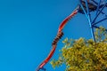 People riding a scary twisting steel rollercoaster at an amusement park.