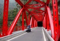 People riding scooter on the red bridge in Hualien, Taiwan