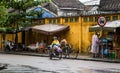 People riding scooter on street in Hoi An, Vietnam Royalty Free Stock Photo