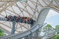 People riding the Tron Lightcycle rollercoaster