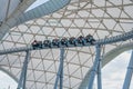 People riding the Tron Lightcycle rollercoaster