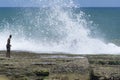 People risking their lives on top of rocks with strong waves