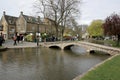 People by the River Windrush in Bourton on the Water in Gloucestershire in the UK
