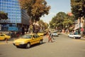 People on the road with line of taxi cars in Iran