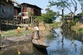 People on rowing a boat at the village of Maing Thauk