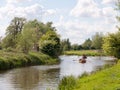 people rowing boats down the river stour in dedham essex uk england in constable country