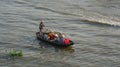 People rowing small boat on river in Vinh Long, Vietnam