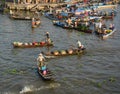 People rowing wooden boats at floating market in Ben Tre, Vietnam