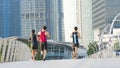 people run in city pedestrian bridge with exterior modern building