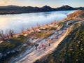 People running at country road near river aerial landscape Royalty Free Stock Photo